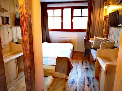 a small room with a bed and a window at Ribno Alpine Hotel in Bled