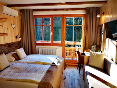a bedroom with a bed and a window at Ribno Alpine Hotel in Bled