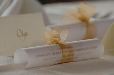 a white rolled up candle with a bow on top at Hotel Grosuplje in Grosuplje
