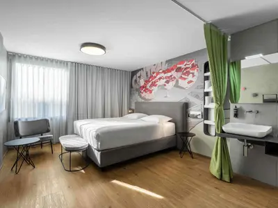 a bedroom with a bed and a sink in it at ibis Styles Ljubljana Centre in Ljubljana