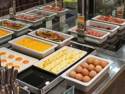 a buffet line with many different types of food at ibis Styles Ljubljana Centre in Ljubljana