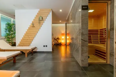 a staircase in a house with a stone wall at Hotel Jezero in Bohinj