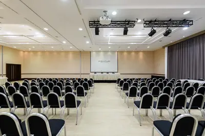 a conference room with chairs and a screen at Exe Lev in Ljubljana