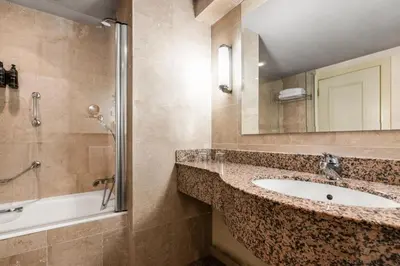 a bathroom with a sink and a shower at Exe Lev in Ljubljana