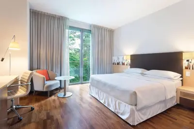 a hotel room with a bed and a desk and a chair at Four Points by Sheraton Ljubljana Mons in Ljubljana