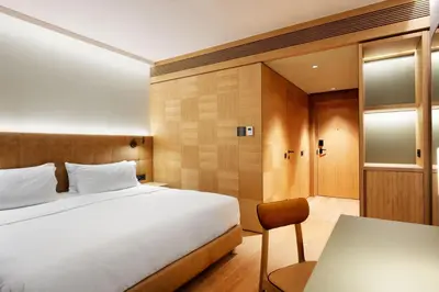 a hotel room with a bed and a desk at Four Points by Sheraton Ljubljana Mons in Ljubljana