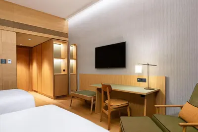 a hotel room with a bed and a desk and a television at Four Points by Sheraton Ljubljana Mons in Ljubljana