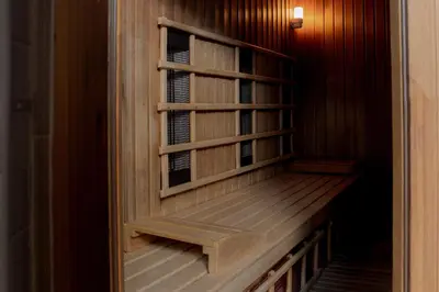 a wooden cabinet with a bench in a room at Hotel Kranjska Gora in Kranjska Gora