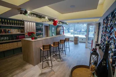 a bar in a restaurant with bar stools at Hotel Kranjska Gora in Kranjska Gora
