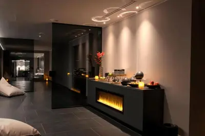 a living room with a fireplace in the wall at Elegans Hotel Brdo in Kranj