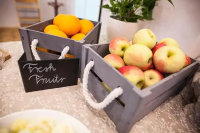 two boxes of apples and oranges on a table at ECO Hotel Center Postojna in Postojna
