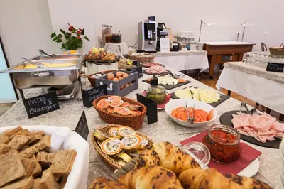 a buffet with bread and other food on a table at ECO Hotel Center Postojna in Postojna