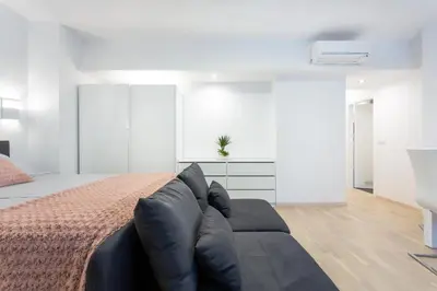 a bedroom with a bed and a couch at Urban Style Apartments by Loft in Ljubljana