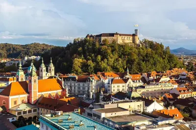 a city with a castle on top of a hill at Urban Style Apartments by Loft in Ljubljana