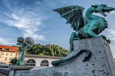 a statue of a green dragon on top of a wall at Urban Style Apartments by Loft in Ljubljana