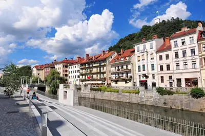 a row of buildings next to a river at Urban Style Apartments by Loft in Ljubljana