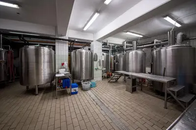 a large kitchen with many tanks in a brewery at Hotel in restavracija Pod Roglo in Zreče