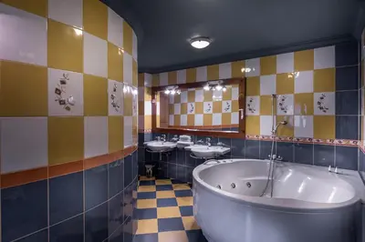 a bathroom with two sinks and a large tub at Hotel in restavracija Pod Roglo in Zreče