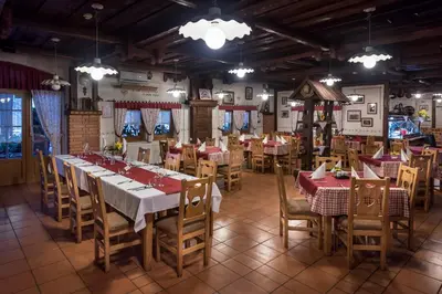 a restaurant with tables and chairs in a room at Hotel in restavracija Pod Roglo in Zreče