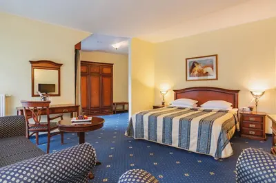 a hotel room with a bed and a desk at Ramada Hotel & Suites Kranjska Gora in Kranjska Gora
