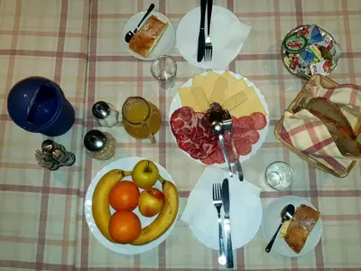 a table with a plate of fruit on it at Pri Ancki Sobe Rooms Accomodation Ljubljana suburbs in Medvode