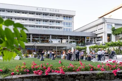 a group of people standing in front of a building at Bled Rose Hotel in Bled