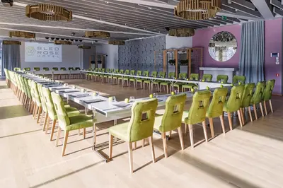 a long dining room with a long table and chairs at Bled Rose Hotel in Bled