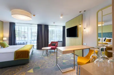 a hotel room with a bed and a desk at Bled Rose Hotel in Bled