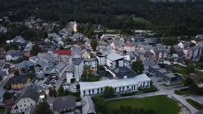 an aerial view of a town with a white building at Hotel Alp in Bovec