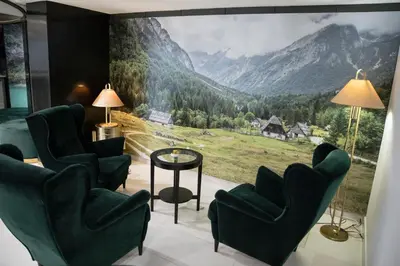 a room with a large mural of a mountain at Hotel Alp in Bovec