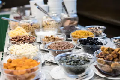 a table topped with bowls of different types of food at Hotel Alp in Bovec