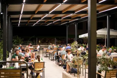 a crowd of people sitting at tables in a restaurant at Hotel Alp in Bovec