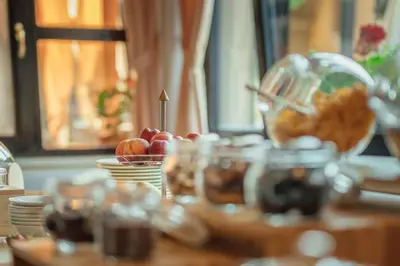 a table topped with bowls of fruit on a table at Garni Hotel Miklič in Kranjska Gora