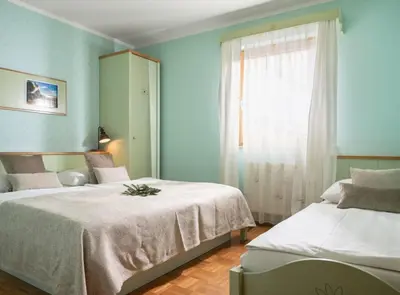 a bedroom with two beds and a window at Eco Terme Snovik, Kamnik in Laze v Tuhinju
