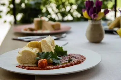 a white plate of food on a table at Eco Terme Snovik, Kamnik in Laze v Tuhinju