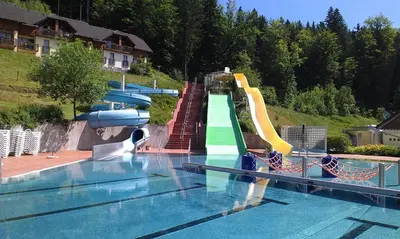 a swimming pool with a water park with a water slide at Eco Terme Snovik, Kamnik in Laze v Tuhinju