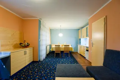 a kitchen with a table and a dining room at Terme Zreče – Vile Terme Zreče in Zreče