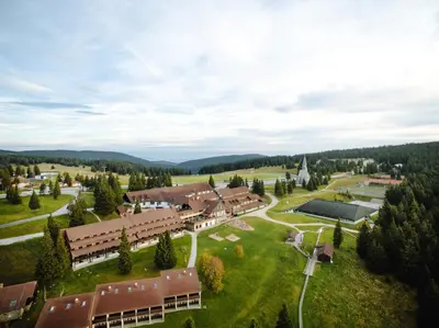 an aerial view of a small village with a building at Hotel Planja in Zreče