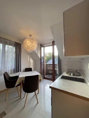 a kitchen with a sink and a table with chairs at Aparthotel Gaja in Bled