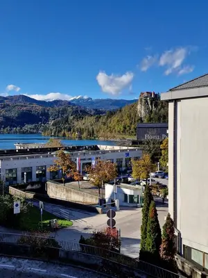 arial view of a city with a mountain in the background at Aparthotel Gaja in Bled