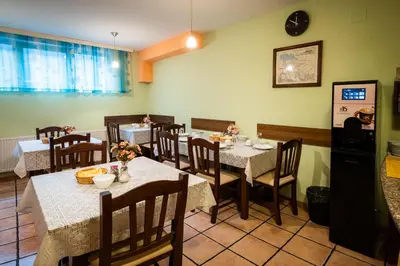 a dining room with tables and chairs with food on them at Penzion Kovac in Radovljica