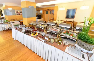 a buffet line with food on it in a room at Hotel Lovec in Bled
