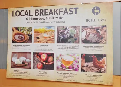 a sign for a local breakfast with pictures of food at Hotel Lovec in Bled