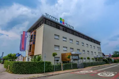 a building with a sign on the top of it at Hotel Tabor Maribor in Maribor