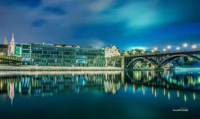a bridge over a river with a city at Hotel Tabor Maribor in Maribor