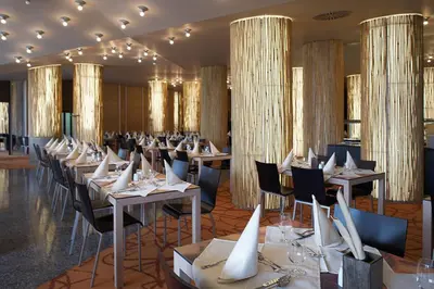 a dining room filled with tables and chairs at Terme Olimia - Hotel Sotelia in Podčetrtek
