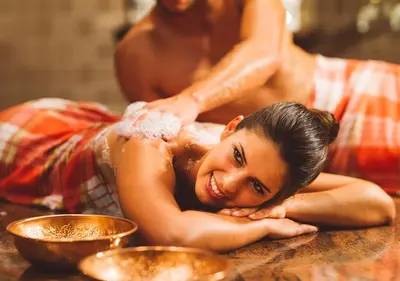 a man giving a woman a massage in a bathtub at Terme Olimia - Hotel Sotelia in Podčetrtek
