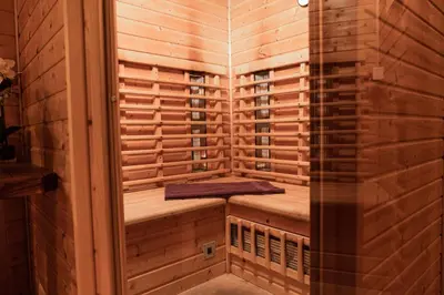 a sauna with wooden paneling and a bench in it at Hotel Medno in Ljubljana