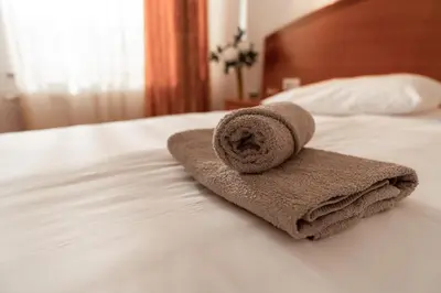 a towel sitting on top of a bed at Hotel Medno in Ljubljana
