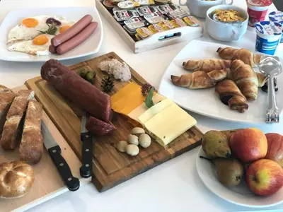 a table with a variety of breakfast foods on it at Hotel Medno in Ljubljana